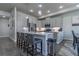 Stylish kitchen featuring a center island with seating, stainless steel appliances, and gray cabinetry at 12254 Hazel Spruce Ct, Parker, CO 80134