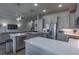 Open concept kitchen featuring a large island, stainless steel appliances, and a view of the living room at 12254 Hazel Spruce Ct, Parker, CO 80134