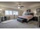 Spacious main bedroom with fan, plush carpeting, and two large sunny windows at 12254 Hazel Spruce Ct, Parker, CO 80134