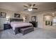 Generous main bedroom suite featuring a ceiling fan and seating area with walk-in access at 12254 Hazel Spruce Ct, Parker, CO 80134