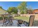 Spacious fenced backyard with a patio area, outdoor furniture, fire pit and lush lawn at 13069 Jackson Dr, Thornton, CO 80241