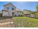 Exterior view of a home with a grassy yard, wood fence, shed, patio with outdoor seating at 13069 Jackson Dr, Thornton, CO 80241