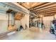 Unfinished basement featuring concrete walls and ceiling, staircase, and washer and dryer hookups at 13069 Jackson Dr, Thornton, CO 80241