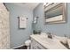 Cozy bathroom with blue walls, updated vanity, framed mirror, and shower with decorative curtain at 13069 Jackson Dr, Thornton, CO 80241