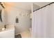 Bright bathroom with white vanity, patterned tile floor, and shower with curtain at 13069 Jackson Dr, Thornton, CO 80241