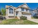 Beautiful two-story home with blue shutters, a well-maintained lawn, and an attached two-car garage at 13069 Jackson Dr, Thornton, CO 80241