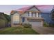 Lovely two-story home with blue shutters, brick accents, and a well-kept front lawn at sunset at 13069 Jackson Dr, Thornton, CO 80241