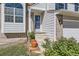 Inviting front entrance with potted plants, brick accents, and well-maintained landscaping at 13069 Jackson Dr, Thornton, CO 80241