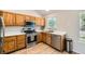 Well-lit kitchen features wood cabinets, stainless steel appliances, and light hardwood flooring at 13069 Jackson Dr, Thornton, CO 80241