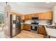 Bright kitchen with stainless steel appliances, wood cabinets, and plenty of counter space at 13069 Jackson Dr, Thornton, CO 80241