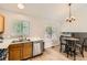 Cozy dining area adjacent to the kitchen with stainless steel dishwasher and lots of light at 13069 Jackson Dr, Thornton, CO 80241