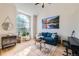 Bright living room with a large arched window, hardwood floors, and modern decor at 13069 Jackson Dr, Thornton, CO 80241