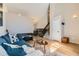 Spacious living room with hardwood floors, a comfortable sofa, and a staircase at 13069 Jackson Dr, Thornton, CO 80241