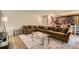 Inviting living room showcasing a spacious sectional sofa, stylish rug, and a staircase to the upper level at 13069 Jackson Dr, Thornton, CO 80241