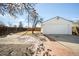 Detached garage in a private backyard with a brick patio, providing convenience and space at 3740 W Exposition Ave, Denver, CO 80219