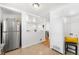 Updated kitchen with stainless steel fridge, white cabinets, and modern finishes at 3740 W Exposition Ave, Denver, CO 80219