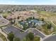 An aerial view shows the school complex and adjacent pool & clubhouse set among residential homes at 1344 S Coolidge Cir, Aurora, CO 80018