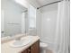 Well-lit bathroom with a vanity, toilet, and a shower-tub combination with white tile at 1344 S Coolidge Cir, Aurora, CO 80018