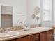 Elegant bathroom featuring double sinks, granite counters, and large mirror at 1344 S Coolidge Cir, Aurora, CO 80018