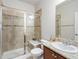 Tiled bathroom featuring a glass shower, granite vanity, and neutral decor at 1344 S Coolidge Cir, Aurora, CO 80018
