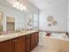 Bright bathroom with double sinks, large mirror, and decorative lighting at 1344 S Coolidge Cir, Aurora, CO 80018