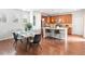 Dining area with a stylish table, hardwood floors, and ample natural light at 1344 S Coolidge Cir, Aurora, CO 80018