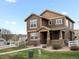 Beautiful two-story home featuring a covered porch and well-maintained front yard at 1344 S Coolidge Cir, Aurora, CO 80018