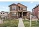 Inviting two-story home with a well-manicured lawn and charming stone accents at 1344 S Coolidge Cir, Aurora, CO 80018