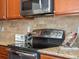 Close-up of modern oven and granite countertops in kitchen at 1344 S Coolidge Cir, Aurora, CO 80018