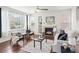 Cozy living room with a fireplace, hardwood floors, and large windows at 1344 S Coolidge Cir, Aurora, CO 80018