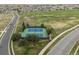Aerial shot of well-maintained outdoor tennis courts surrounded by lush green space and residential area at 1344 S Coolidge Cir, Aurora, CO 80018