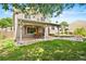 Spacious backyard with a covered patio, ideal for outdoor dining and entertaining with its cozy ambiance at 11530 Elm Ct, Thornton, CO 80233