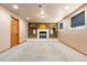 Finished basement room with carpet, a fireplace, and windows, showcasing a cozy living space at 11530 Elm Ct, Thornton, CO 80233