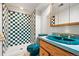 Unique bathroom featuring a green and white checkered tile shower and blue fixtures at 11530 Elm Ct, Thornton, CO 80233
