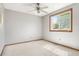 A bedroom with neutral paint, carpet, a ceiling fan, and a window looking out onto trees at 11530 Elm Ct, Thornton, CO 80233