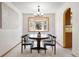 Inviting dining room with a large bay window and adjacent view into the kitchen at 11530 Elm Ct, Thornton, CO 80233