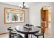 Inviting dining room with a large bay window and traditional decor with a view into the kitchen at 11530 Elm Ct, Thornton, CO 80233