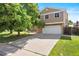 Charming two-story home with a spacious driveway and well-manicured lawn and a two-car garage at 11530 Elm Ct, Thornton, CO 80233