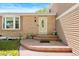 Inviting front porch featuring a decorative door, flowers, and a brick facade at 11530 Elm Ct, Thornton, CO 80233