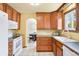 Well-maintained kitchen featuring wooden cabinetry, white appliances, and neutral countertops at 11530 Elm Ct, Thornton, CO 80233