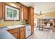 Bright kitchen with a double sink, window views, and an adjacent breakfast nook area at 11530 Elm Ct, Thornton, CO 80233