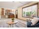 Open-concept living area with a kitchen view, outdoor access, and comfortable seating at 11530 Elm Ct, Thornton, CO 80233