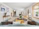 Spacious living room featuring white walls, a large bay window, staircase, and bright natural light at 11530 Elm Ct, Thornton, CO 80233