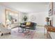 Bright living room featuring a large bay window, neutral carpet, and a decorative rug at 11530 Elm Ct, Thornton, CO 80233