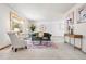 Bright living room featuring a large bay window, neutral carpet, and a decorative rug at 11530 Elm Ct, Thornton, CO 80233