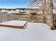 Fenced backyard with a wooden deck covered in snow, offering a private outdoor space at 3061 W 92Nd Ave # 11B, Westminster, CO 80031