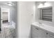 Bright bathroom with a white vanity, a large mirror, and a shower-tub combo at 3061 W 92Nd Ave # 11B, Westminster, CO 80031