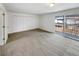 Bright bedroom with neutral carpet, three closets, and sliding glass doors to outdoor deck at 3061 W 92Nd Ave # 11B, Westminster, CO 80031