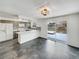 Kitchen and dining area featuring gray cabinets, tile backsplash, breakfast bar, and sliding glass door to backyard at 3061 W 92Nd Ave # 11B, Westminster, CO 80031