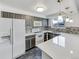 Modern kitchen with white countertops, gray cabinets, and stainless steel appliances at 3061 W 92Nd Ave # 11B, Westminster, CO 80031